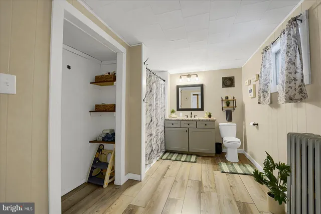 a room with a wooden floor and cabinets