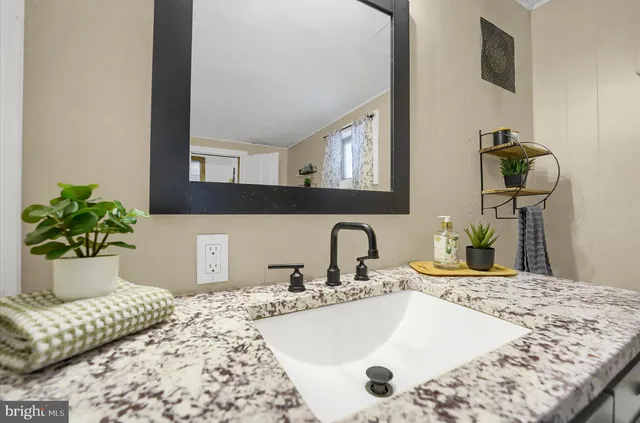 a bathroom with a bathtub sink and mirror