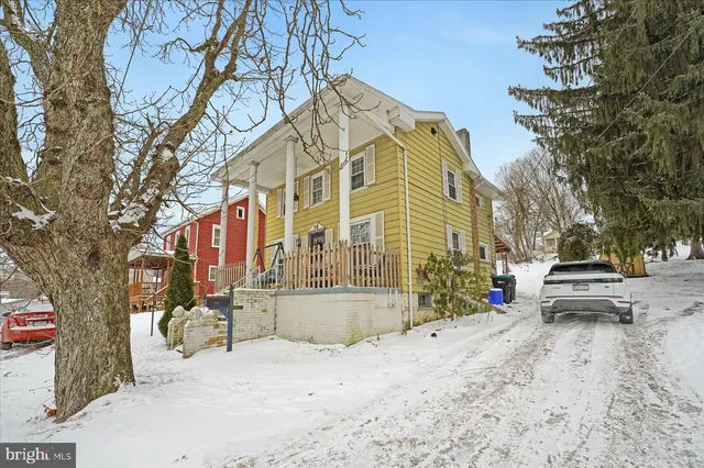 a view of a building with snow on the road