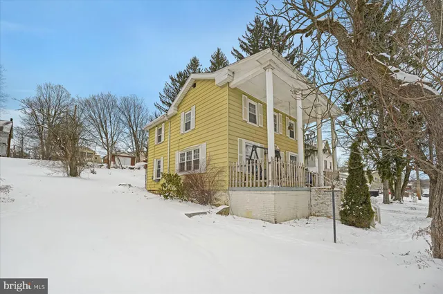 a view of a house with snow on the road