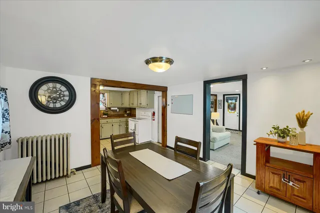 a view of a room with a table and chairs