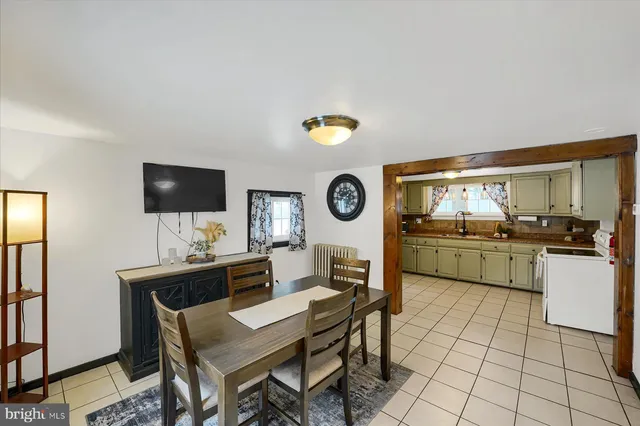 a kitchen with a dining table and chairs