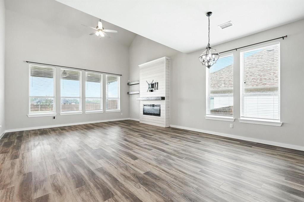 4203 Parrot Lane Sherman, TX 75092 - Photo 12 of 38 a view of an empty room with a window and wooden floor