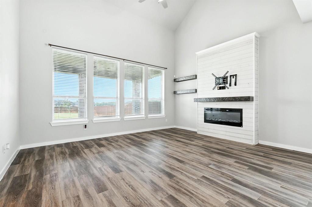 4203 Parrot Lane Sherman, TX 75092 - Photo 13 of 38 a view of empty room with wooden floor and fireplace