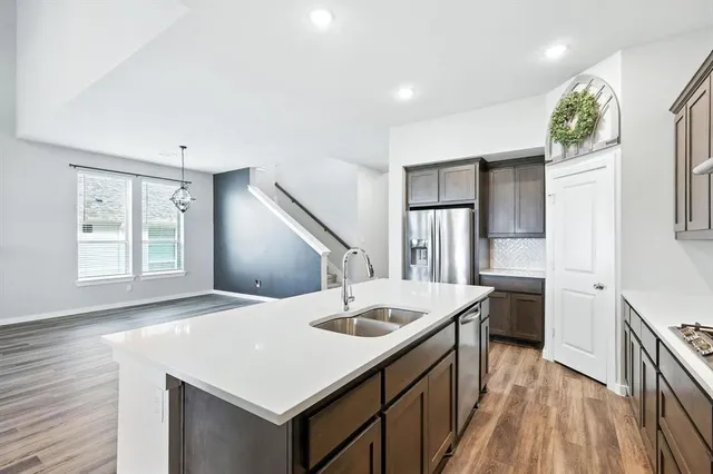 a kitchen with a sink a stove and refrigerator