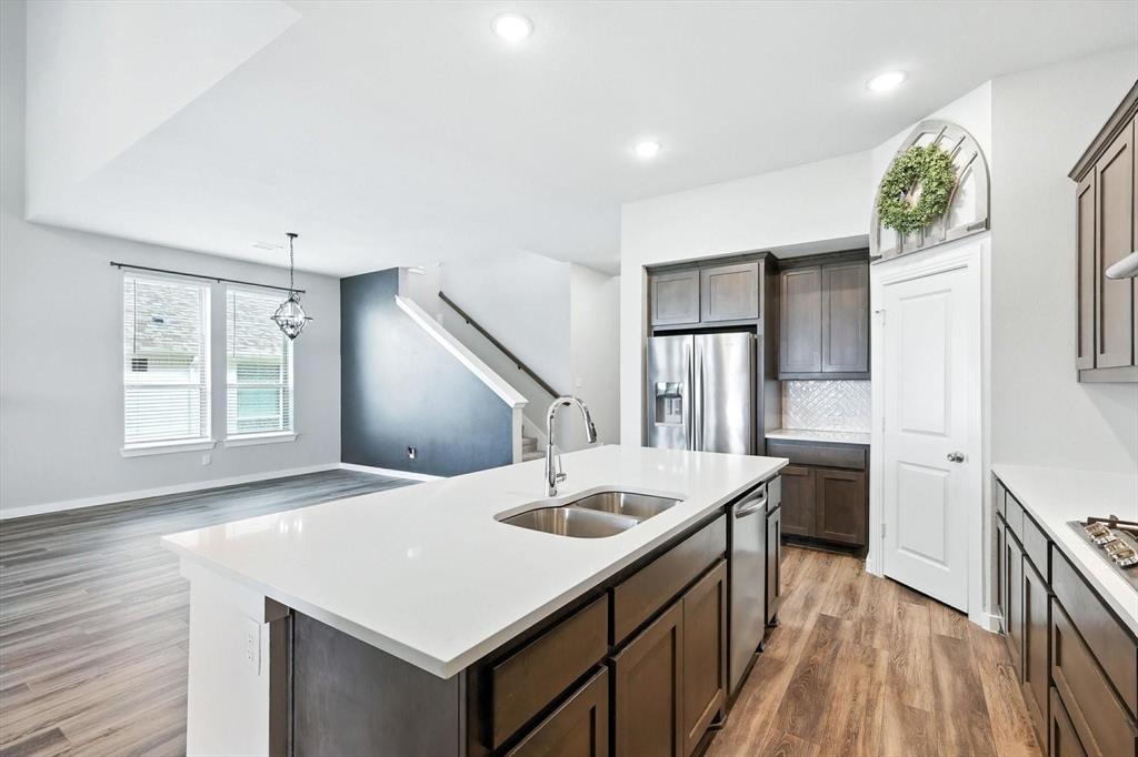4203 Parrot Lane Sherman, TX 75092 - Photo 14 of 38 a kitchen with a sink a stove and refrigerator