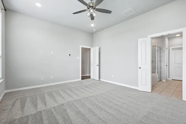 wooden floor in an empty room with a ceiling fan