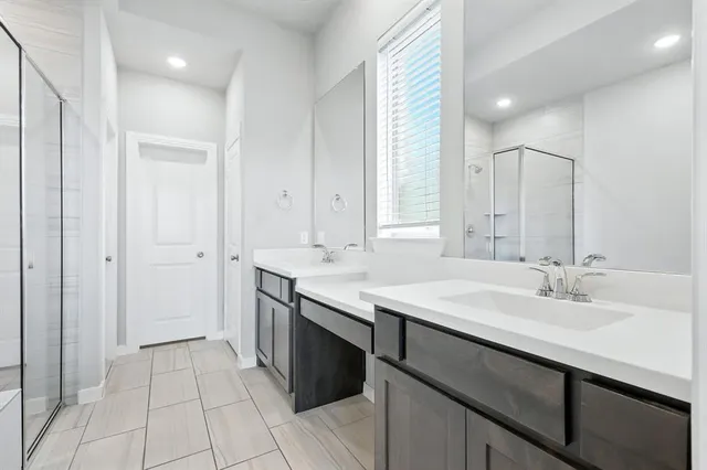 a bathroom with a sink double vanity and a mirror
