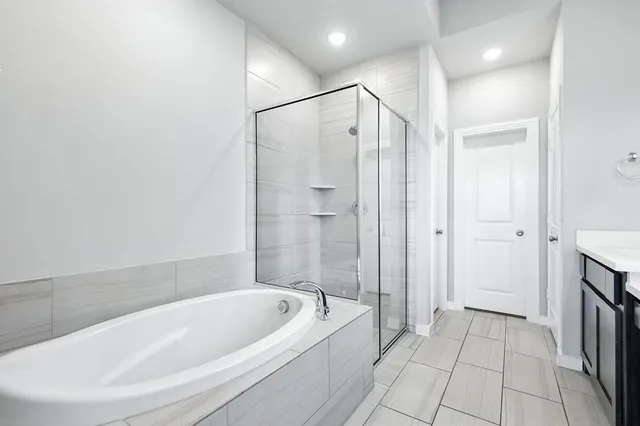 a bathroom with a bathtub and a shower