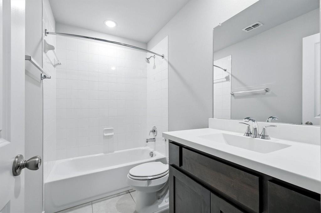 4203 Parrot Lane Sherman, TX 75092 - Photo 31 of 38 a bathroom with a sink a toilet and shower