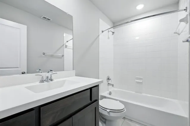 a bathroom with a sink a toilet and a bathtub