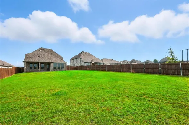 a view of a garden with wooden fence