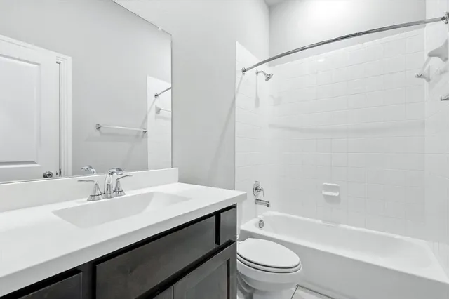 a bathroom with a sink a toilet and a bathtub