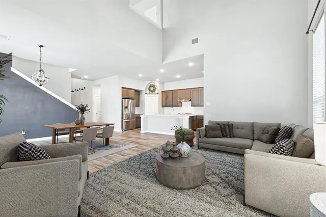 a living room with furniture and a dining table