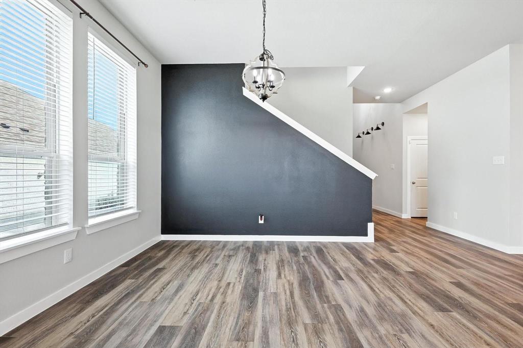 4203 Parrot Lane Sherman, TX 75092 - Photo 8 of 38 a view of an empty room with wooden floor and a window