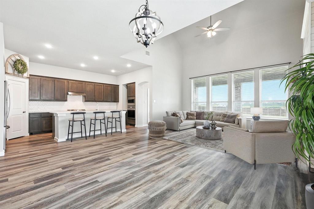 4203 Parrot Lane Sherman, TX 75092 - Photo 9 of 38 a living room with furniture a fireplace and a dining table with wooden floor