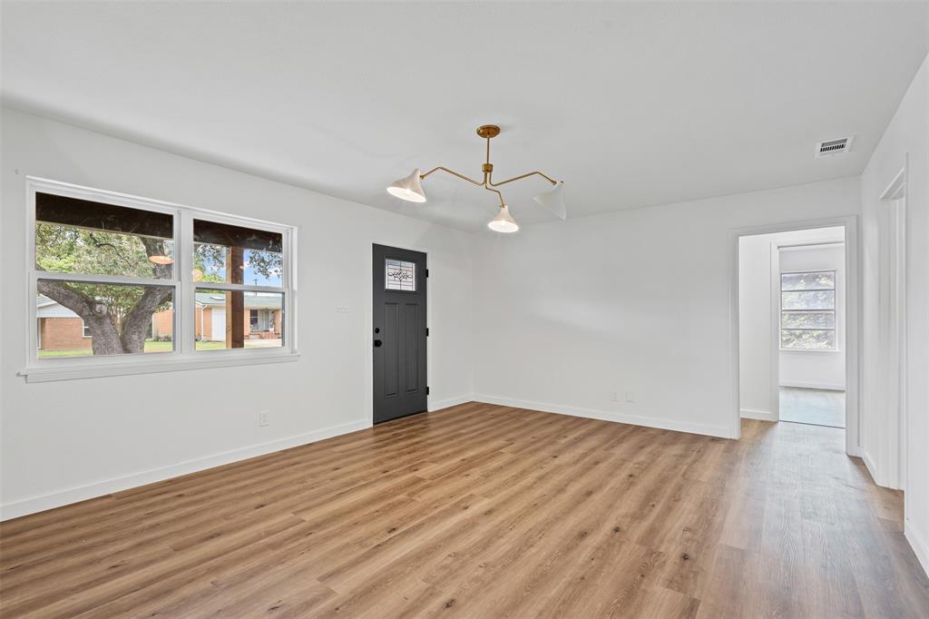 4920 Rector Avenue Fort Worth, TX 76133 - Photo 11 of 37 a view of an empty room with wooden floor and a window