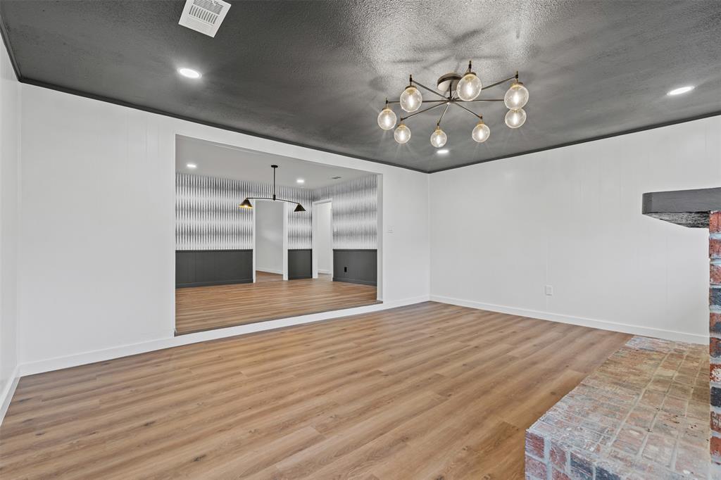 4920 Rector Avenue Fort Worth, TX 76133 - Photo 19 of 37 an empty room with wooden floor chandelier and entryway