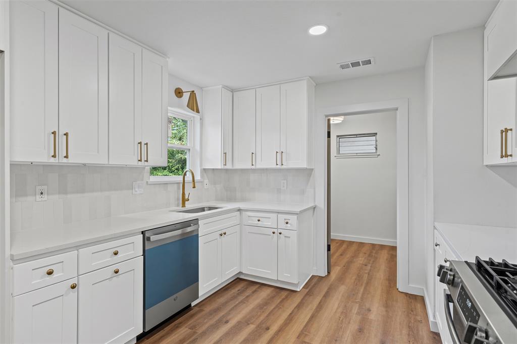 4920 Rector Avenue Fort Worth, TX 76133 - Photo 22 of 37 a kitchen with sink cabinets and wooden floor