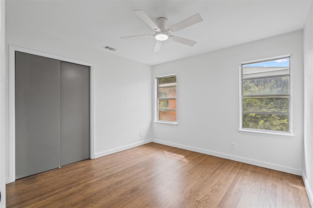 4920 Rector Avenue Fort Worth, TX 76133 - Photo 27 of 37 a view of an empty room with wooden floor and a window