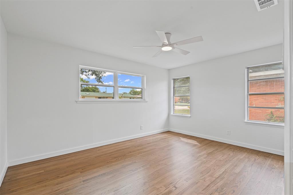 4920 Rector Avenue Fort Worth, TX 76133 - Photo 28 of 37 a view of an empty room with wooden floor and a window