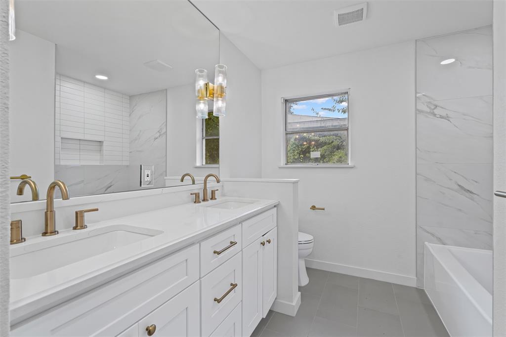4920 Rector Avenue Fort Worth, TX 76133 - Photo 29 of 37 a bathroom with a double vanity sink and a mirror