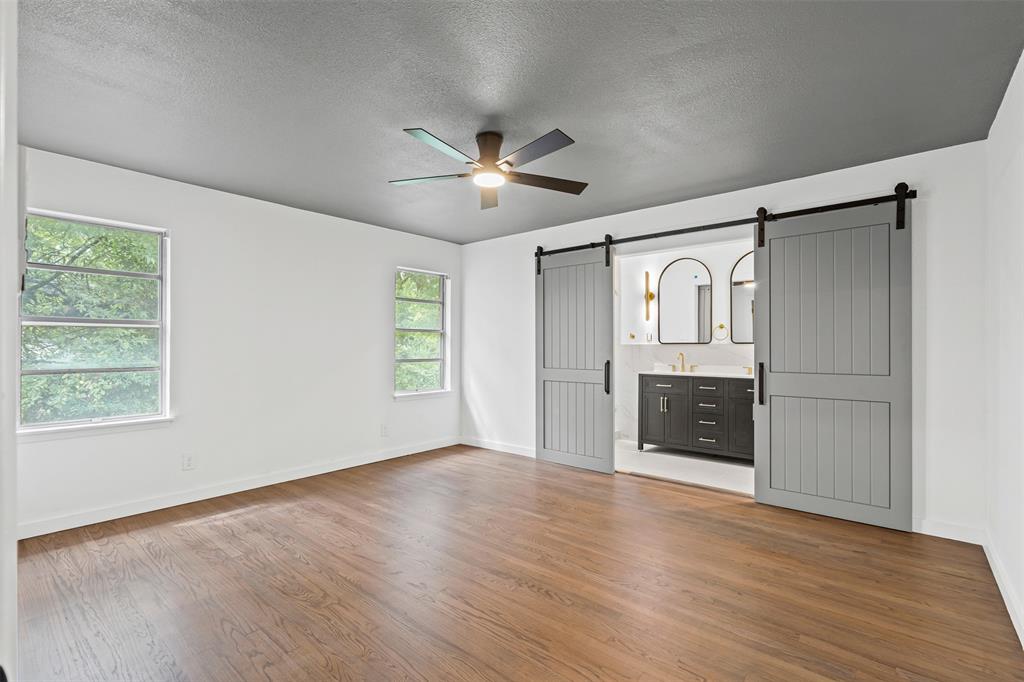 4920 Rector Avenue Fort Worth, TX 76133 - Photo 31 of 37 a view of an empty room with a kitchen and wooden floor
