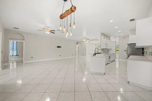 a kitchen with a stove refrigerator and cabinets