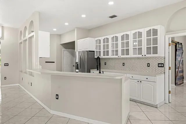 a kitchen with white cabinets and white appliances