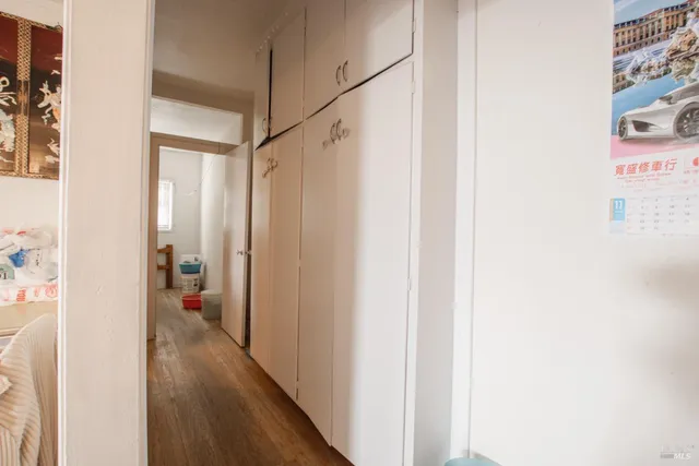 a view of a room with wooden floor