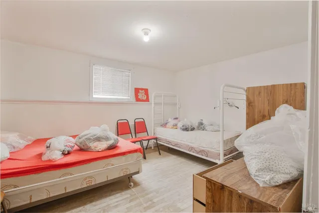 a view of a room with wooden floor a sink and a window