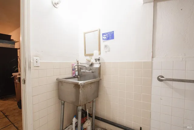 a bathroom with a toilet a sink and a mirror