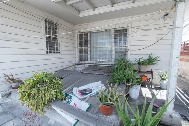 a utility room with lots of clutter and washer