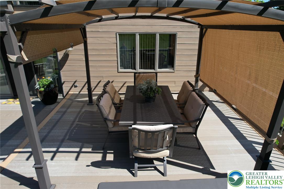 3470 Brodhead Road Bethlehem, PA 18020 - Photo 18 of 84 An inviting deck features a shaded dining area perfect for outdoor entertaining.