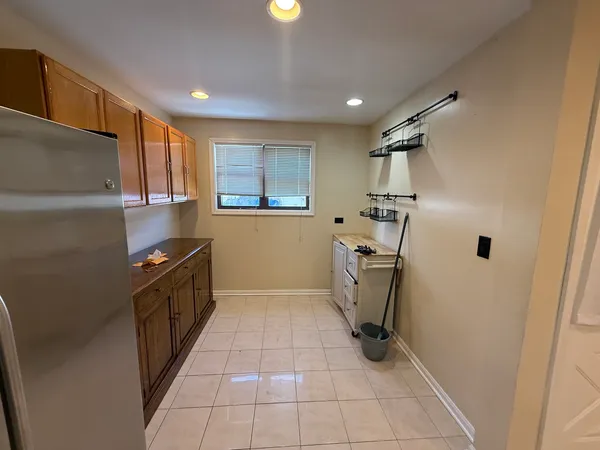 a kitchen with a refrigerator and a sink