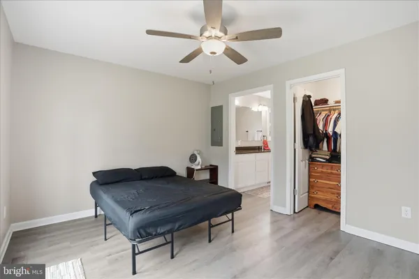 a living room with furniture and a hallway