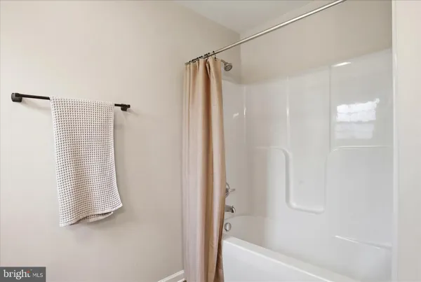 a bathroom with a shower and a tub