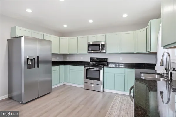 a kitchen with a refrigerator stove and microwave