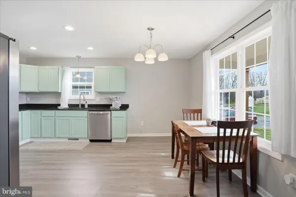 a kitchen with a table and chairs in it