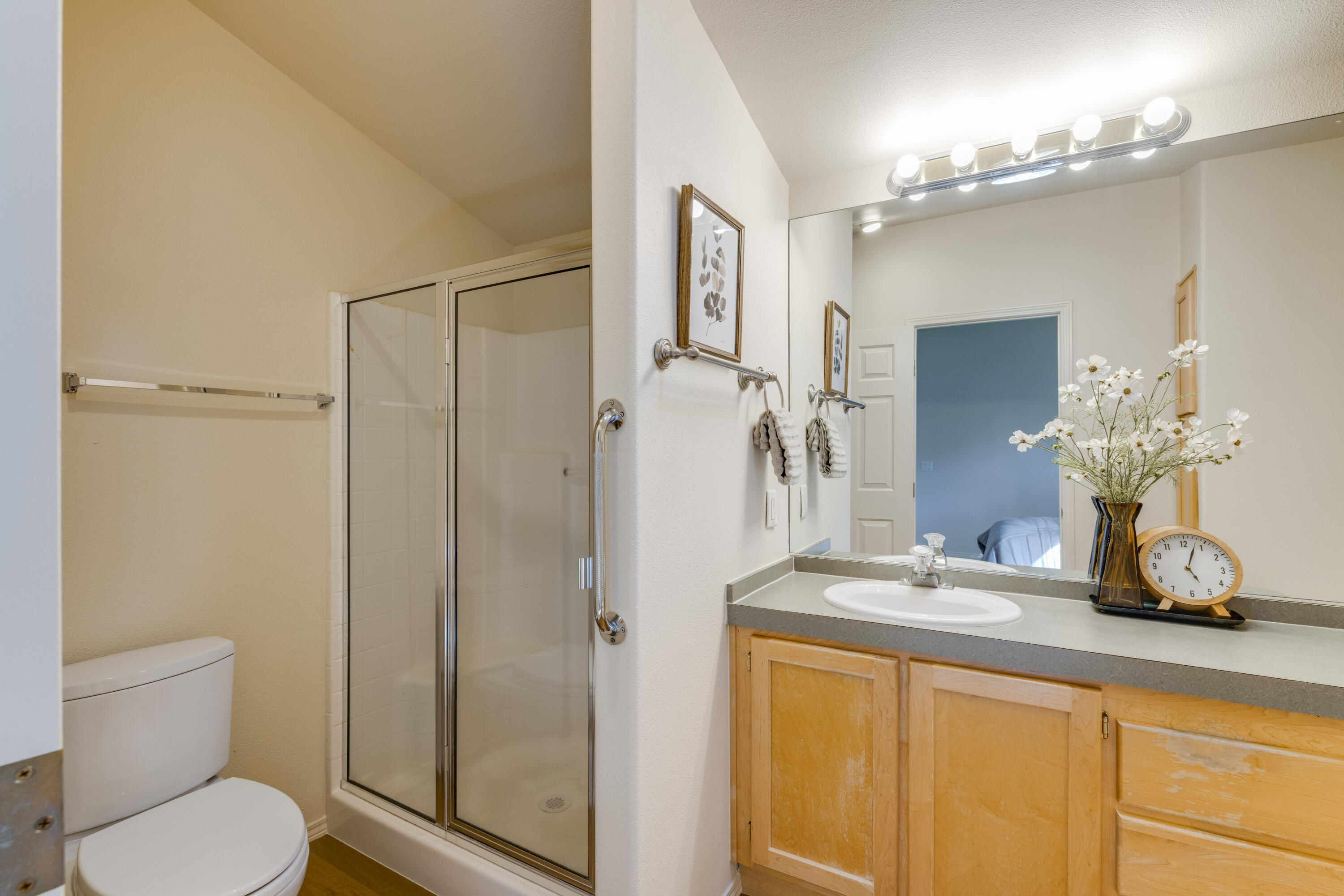 278 North Wheeler Loop Sisters, OR 97759 - Photo 13 of 22 a bathroom with a granite countertop sink a toilet and a mirror