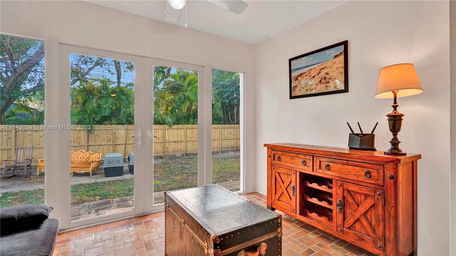152 Northwest 103rd Street Miami Shores, FL 33150 - Photo 12 of 27 a living room with furniture a floor to ceiling window and a flat screen tv
