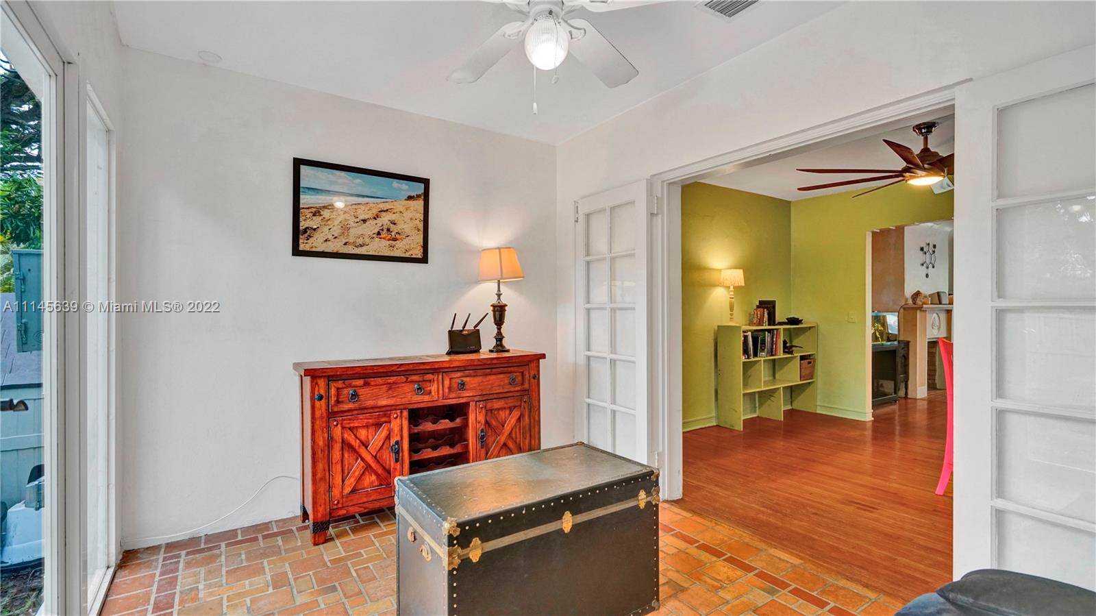 152 Northwest 103rd Street Miami Shores, FL 33150 - Photo 13 of 27 a living room with stainless steel appliances kitchen island granite countertop a refrigerator and a sink
