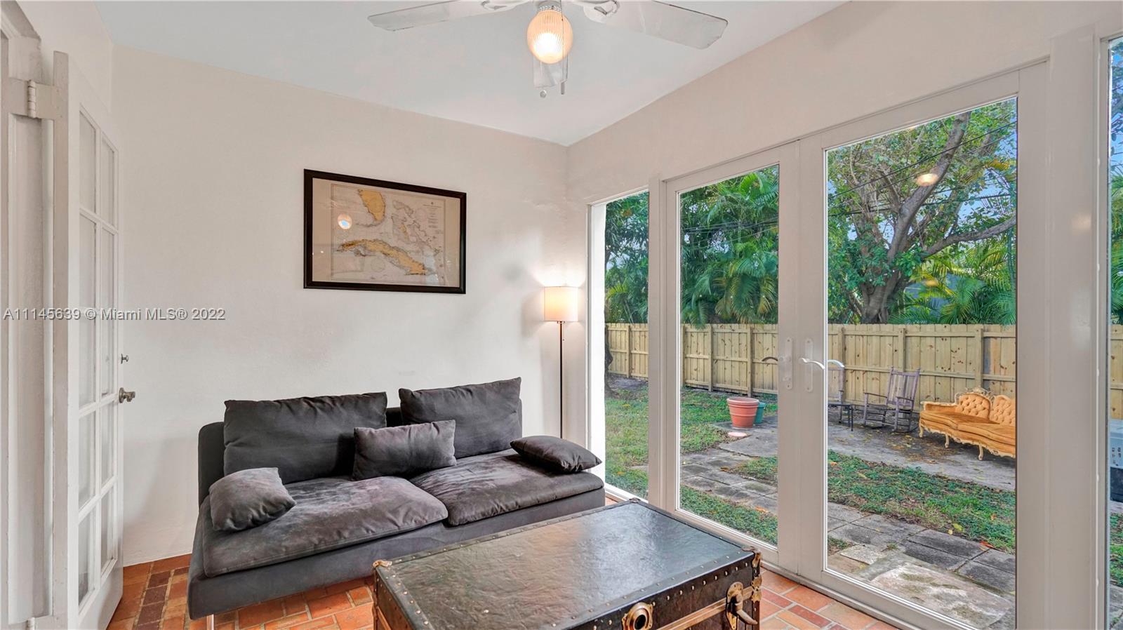 152 Northwest 103rd Street Miami Shores, FL 33150 - Photo 14 of 27 a living room with furniture and a large window