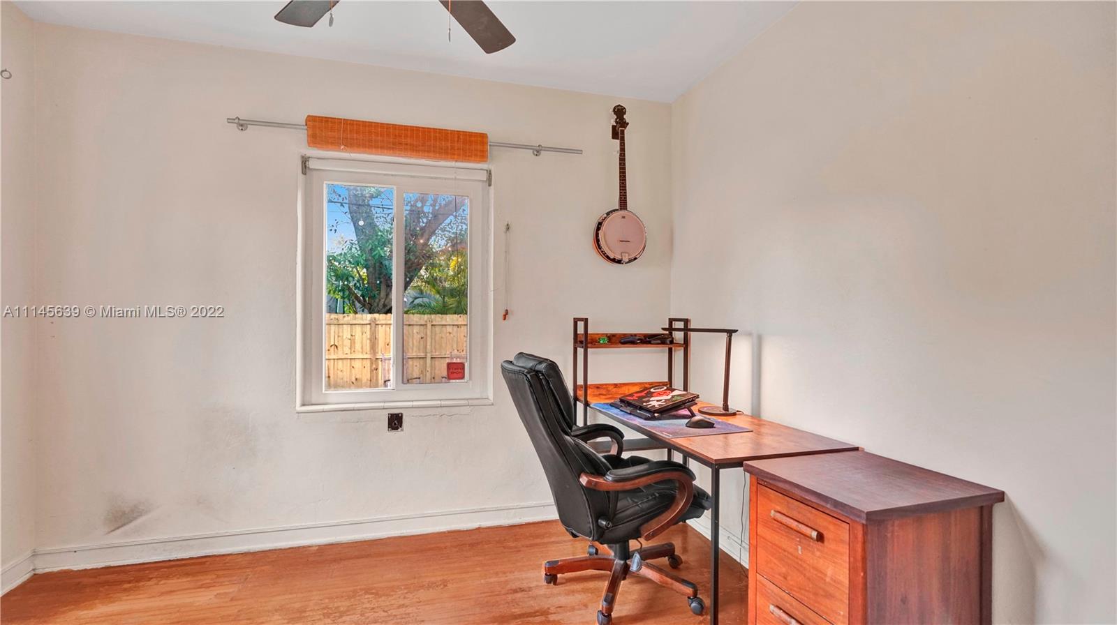 152 Northwest 103rd Street Miami Shores, FL 33150 - Photo 19 of 27 a view of a workspace with furniture and a window
