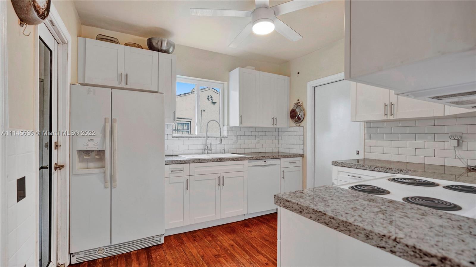 152 Northwest 103rd Street Miami Shores, FL 33150 - Photo 22 of 27 a kitchen with a sink stove and refrigerator