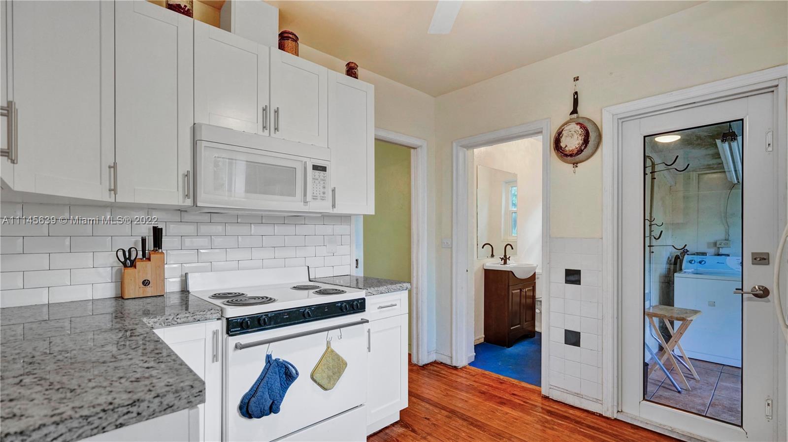 152 Northwest 103rd Street Miami Shores, FL 33150 - Photo 23 of 27 a kitchen with stainless steel appliances granite countertop a refrigerator and a stove