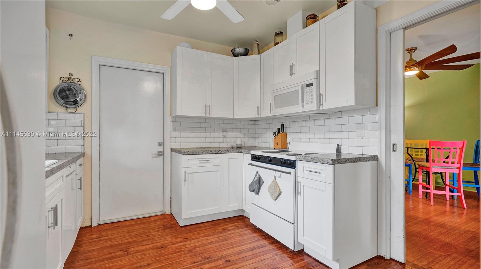 152 Northwest 103rd Street Miami Shores, FL 33150 - Photo 24 of 27 a kitchen with stainless steel appliances granite countertop a stove a sink and a refrigerator