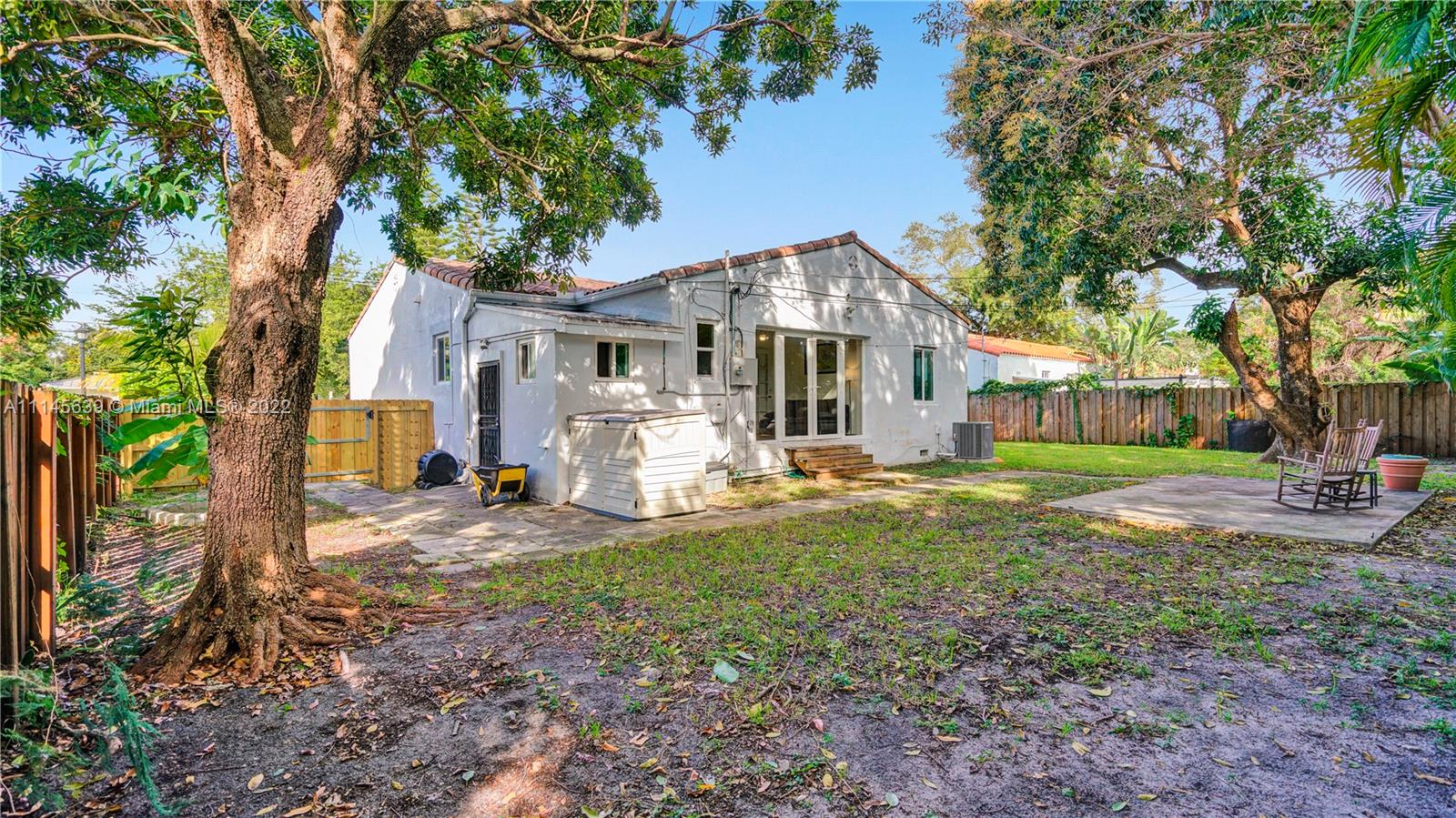 152 Northwest 103rd Street Miami Shores, FL 33150 - Photo 3 of 27 a front view of a house with a yard and trees