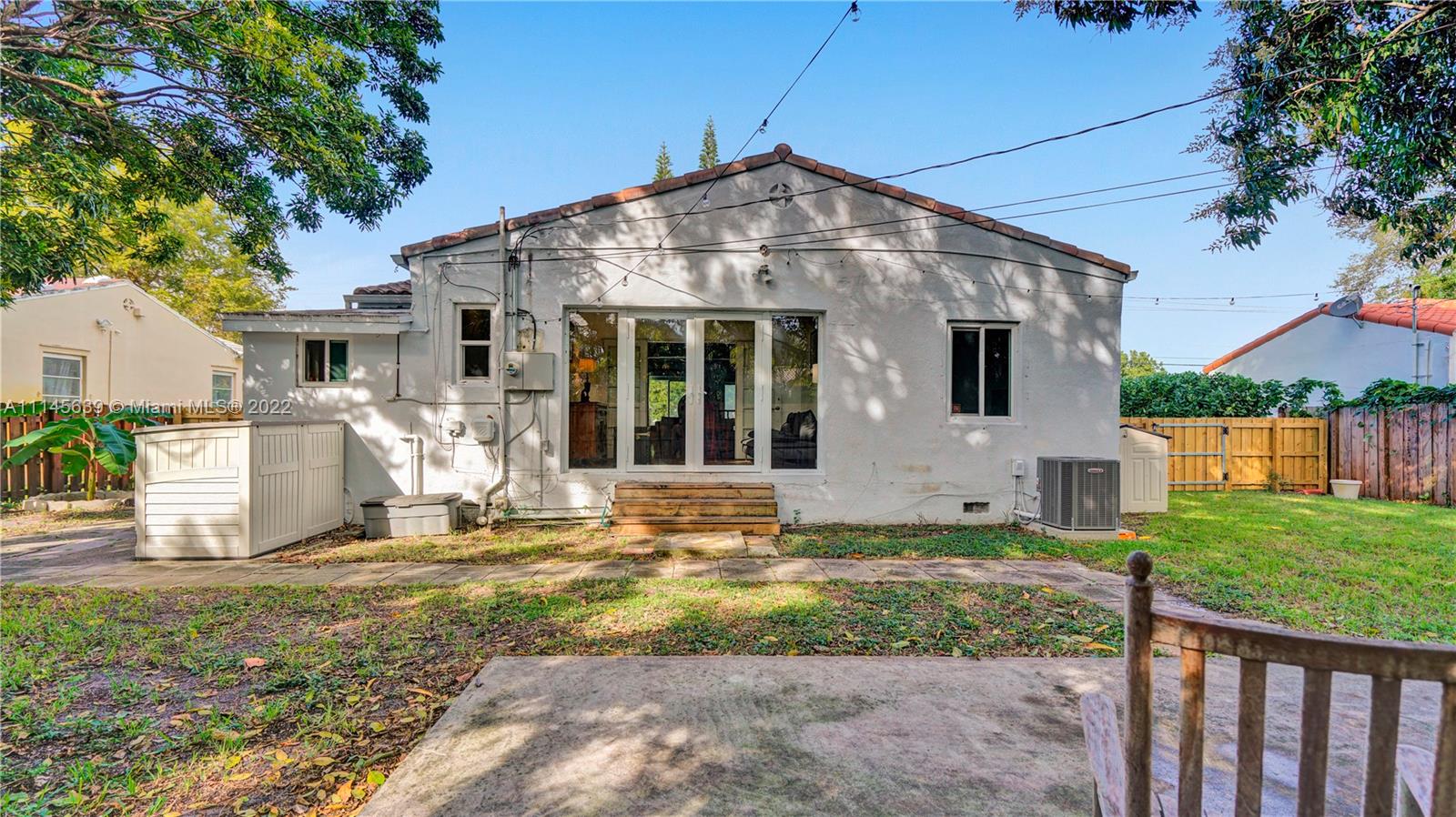 152 Northwest 103rd Street Miami Shores, FL 33150 - Photo 4 of 27 a front view of a house with a yard