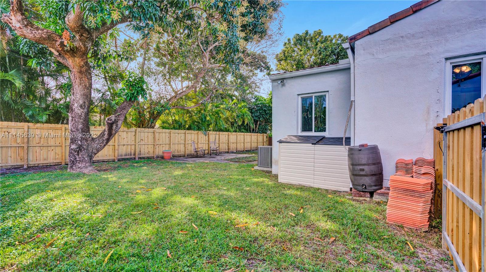 152 Northwest 103rd Street Miami Shores, FL 33150 - Photo 6 of 27 a view of a backyard with a plants and large tree